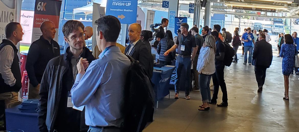 Attendees at exhibit booths at the Mash-Up event