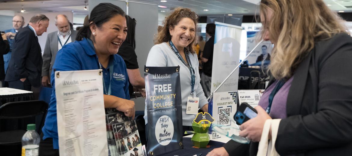Women conversing at an exhibit table
